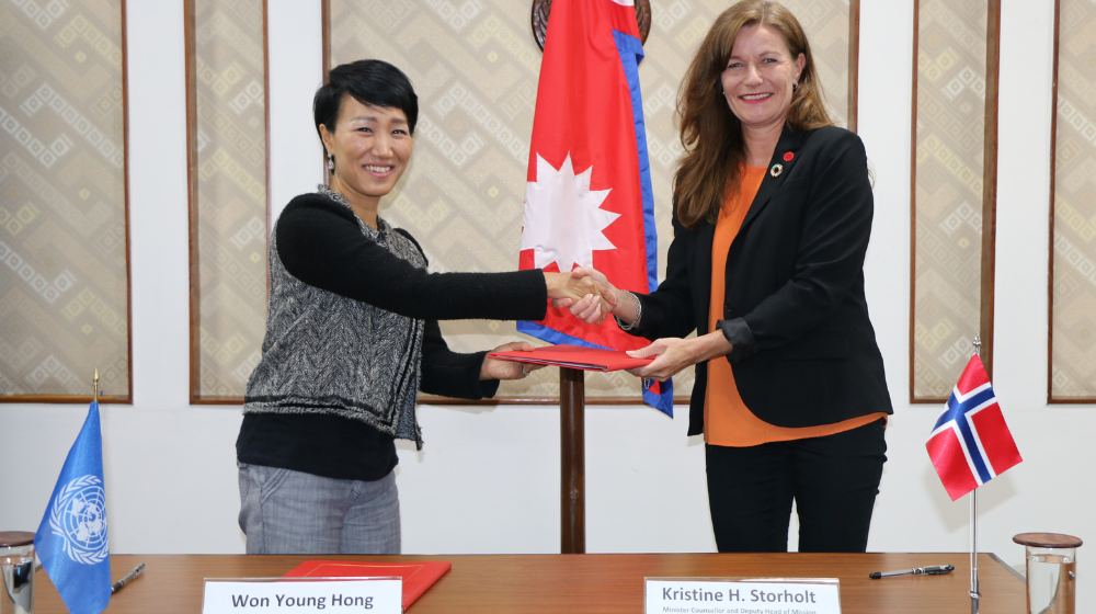 Photo depicts the Deputy Head of Mission of the Royal Norwegian Embassy of Nepal and UNFPA Rep signing the agreement