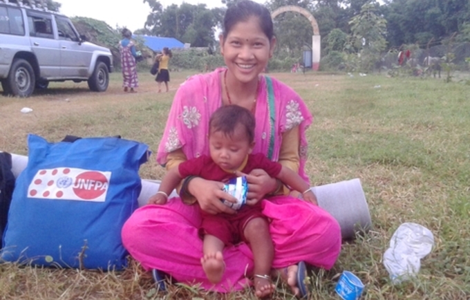 Ever since Bismati Tharu started living in a shared tent following the floods, she had no spare clothes to change for herself and her baby.  Photo: © UNFPA Nepal/Purna Nepali