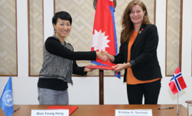 Photo depicts the Deputy Head of Mission of the Royal Norwegian Embassy of Nepal and UNFPA Rep signing the agreement