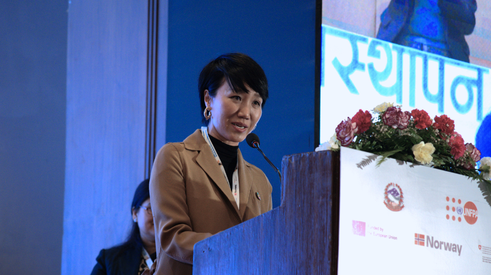 UNFPA Representative Won Young Hong at the podium at the National OCMC Conference.