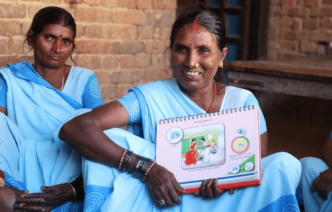 Local volunteers show Nepali families the benefits of voluntary family planning. ©UNFPA Nepal