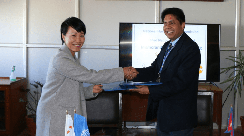 Picture depicts the partnership signing between UNFPA and the NHRC